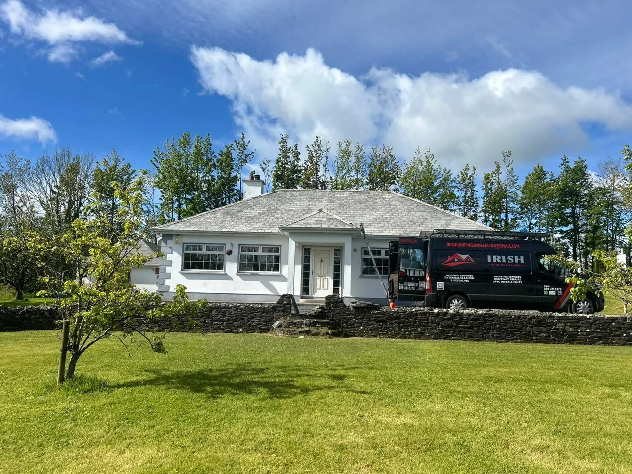 Freshly painted and sealed bungalow roof with Irish Roofing and Sealing branded van parked outside on a sunny day — completed job